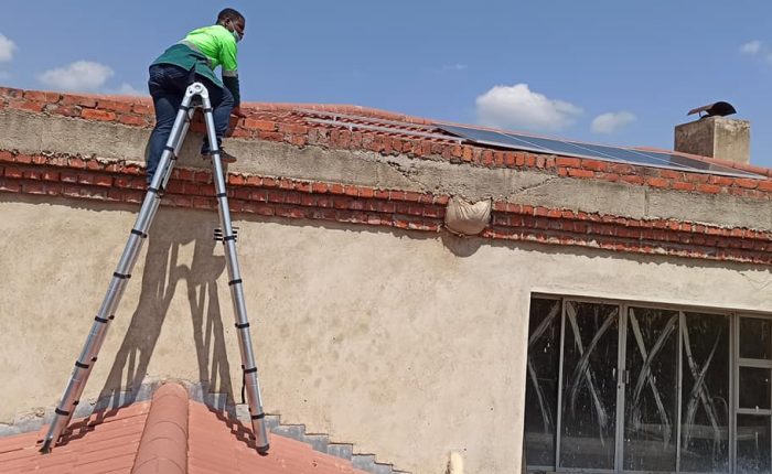 Man climbing up the ladder to install residential solar system
