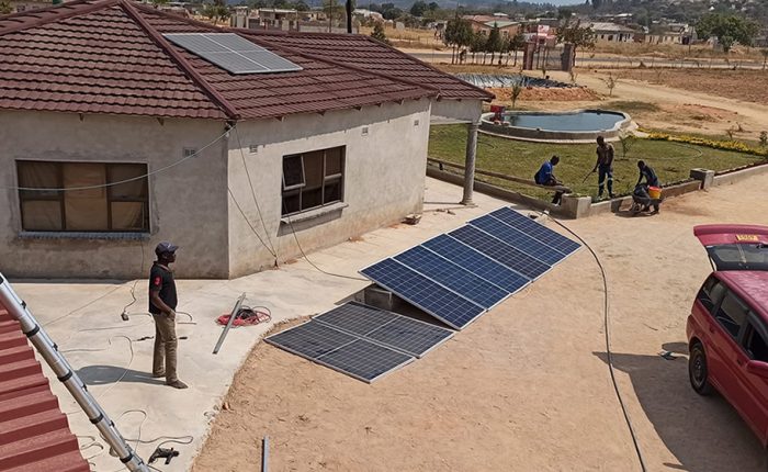 Men assembling solar panels and equipment for installation